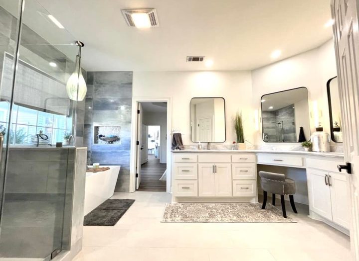 a luxury bathroom with enclosed shower, bathtub and a powder area with three corner rounded mirrors